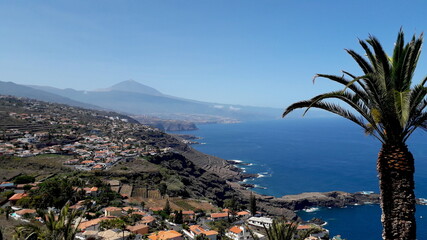 beautiful Tenerife north coast with the Teide volcano on the background. Panoramic view of Tenerife turistic north coast with villages on cliffs and plantations