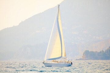 Yacht with a large mast . Modern luxury boat sailing in the twilight 