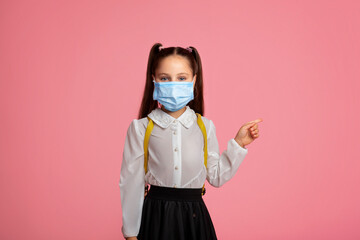 Education during quarantine covid. Child girl in uniform and protective mask