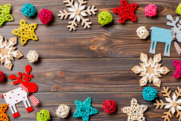 Top view of Christmas decorations and toys on wooden background. Copy space. Empty place for your design. New Year concept