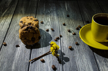 Still life with cup of coffee and chocolate cakes on the grey background