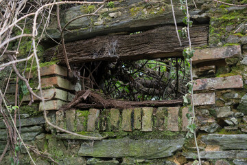 Old wooden lintel above the window of an abandoned house.