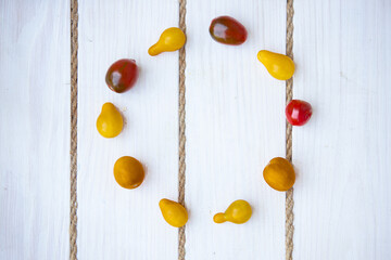 flat lay with colorful tomatoes in circle with empty space in middle. soft focus. top view