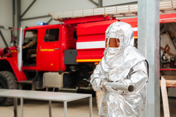 Fireman in a special foil protective suit 