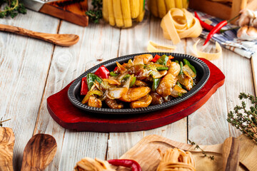 Roasted meat with vegetables in cast iron pan