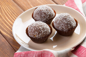 Chocolate balls in coconut shavings close up