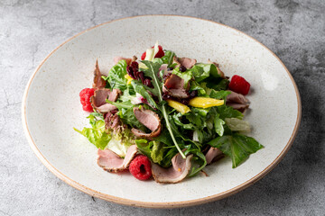 Rocket and ham salad on grey concrete background