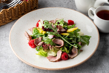 Rocket and ham salad on grey concrete background