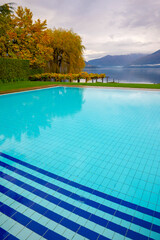 Swimming Pool and Alpine Lake Maggiore with Mountain in Ticino, Switzerland.