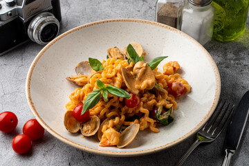 Mussel pasta with creamy sauce, menu photo with artificial light