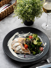 Typical dietary dinner: boiled chicken breast, broccoli and a glass of white wine
