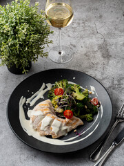 Typical dietary dinner: boiled chicken breast, broccoli and a glass of white wine