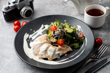 Top view of a healthy restaurant meal: boiled chicken breast, broccoli