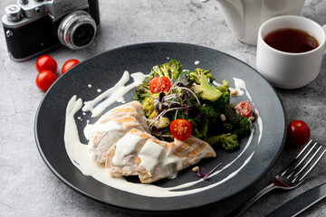 Top view of a healthy restaurant meal: boiled chicken breast, broccoli