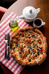 Italian cafe with pizza, oil bottles and typical red and white cloth