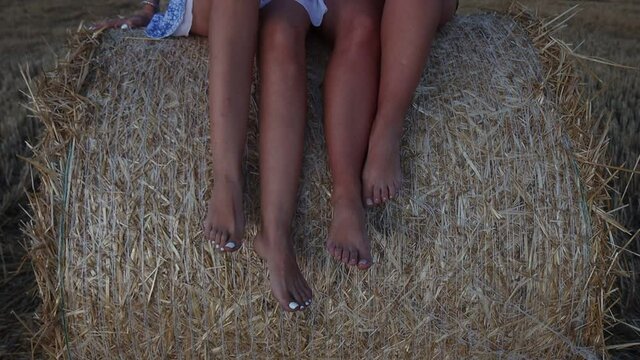 beautiful girls feet on a haystack