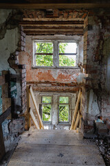Fototapeta na wymiar Damaged windows of a ruined mansion