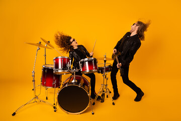 Full size photo crazy two people girlfriend boyfriend enjoy record studio composition ma play bass solo guitar girl drum scream wear leather outfit isolated bright shine color background