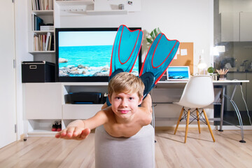 Boy mask and snorkel dive imitating swimming TV