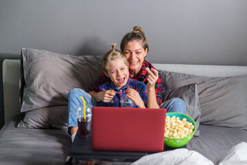 Family mom and son watching movie online in laptop
