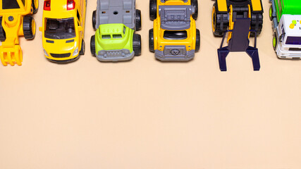 Lots of toy cars on a beige background banner with a place for text for a toy store.