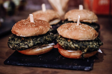 Vegetarian large burgers with spinach. Selective focus.