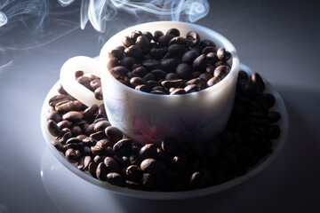 coffee beans in a cup with fumes