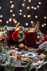  Two glasses of mulled wine in New Year's surroundings, hot wine. Beautiful Christmas background, vertical photo