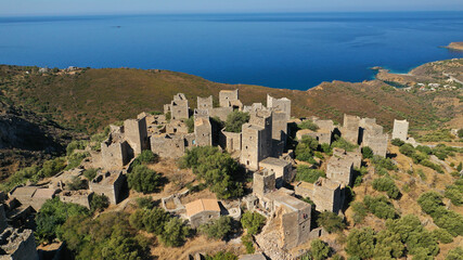 Fototapeta premium Aerial drone photo of picturesque abandoned old stone tower village of Vatheia overlooking deep blue sea in Mani Peninsula, Peloponnese, Greece