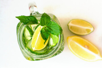 Health care, fitness, healthy nutrition diet concept. Fresh cool lemon cucumber mint infused water, cocktail, detox drink, lemonade in a glass jar.