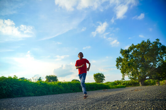 Happy indian child running on road - Powered by Adobe
