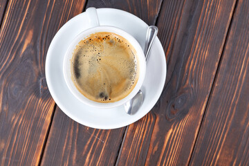 cup of coffee on the wooden background
