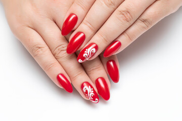 Gel nails. Red manicure on sharp long nails close-up on a white background. White monograms and crystals.