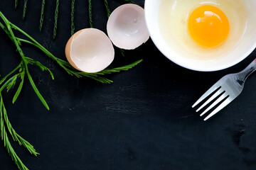 Egg with protein and Climbing Wattle omelette. Place on a black background, top view, free space for your text. The concept of nutrition the body.