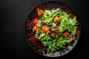 Caesar salad with croutons, cheese, eggs, tomatoes and grilled chicken on wooden table.