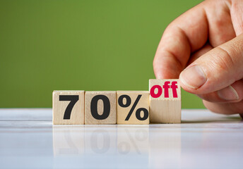 The hand turn wooden block and change word to 70% off. Sale background concept