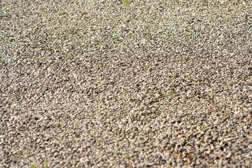 small road stone background, dark gravel pebbles stone texture. Closeup top view gravel. Gravel in garden. Pattern