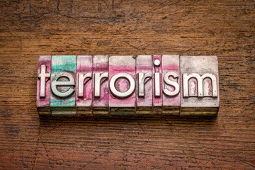 terrorism word abstract in gritty vintage letterpress metal types, social concept