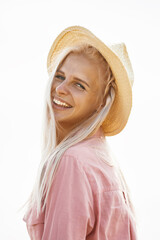 Woman with long blond hair and a straw hat in a wheat field.