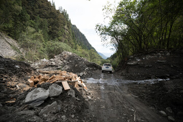 Driving on trail in high altitude forest mountain