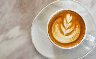 Texture of latte art, Top view white coffee cup on marble table.