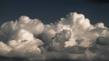 Cumulus clouds on overcast sky.