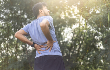 Young Asian runner sustains a back pain injury, Sport injury, Man with back pain