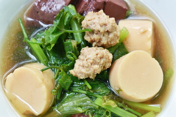 boiled vegetable gourd minced pork and blood with egg tofu soup on bowl