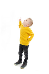 Full length of casual little boy pointing on copy space. Isolated on white background 

