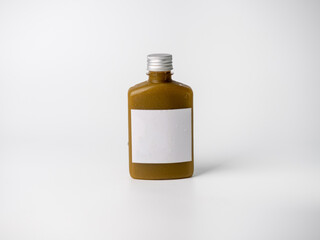 brown pastel color drink in plastic bottle container with empty logo label. mixed many vegetables and fruits smoothie juice on studio background.
