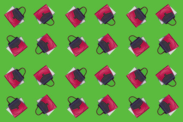 Bright multicolored handbag on a green background, flat lay, creative design for packaging. Concept of purchases, discounts, holiday sales.