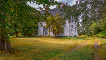Old House in the countryside - A rural house in Nova Scotia's countryside on a late summer's day as autumn nears.