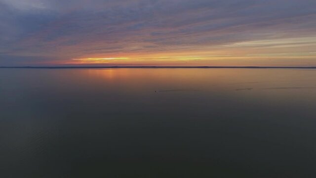Yacht Far in the Curonian Lagoon at Sunset. Aerial Track Right Pedestal Down