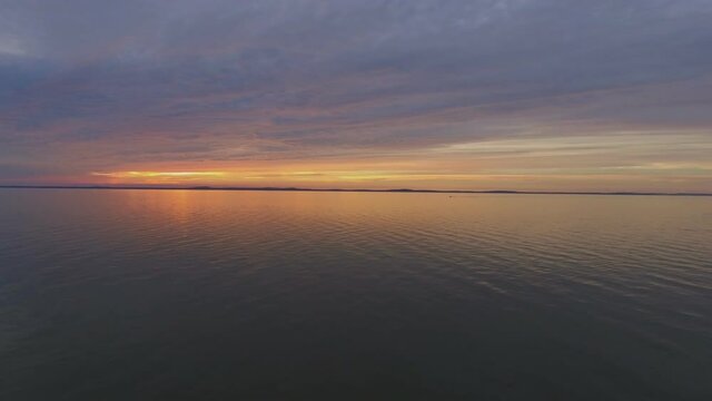 One Yacht Far in the Curonian Lagoon at Sunset. Aerial Lift Up